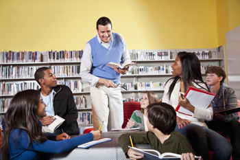 teacher leading book discussion in library